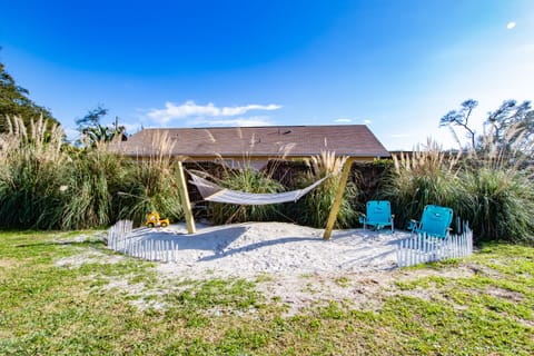 Backyard oasis with hammock, beach chairs, and space to relax and play.
