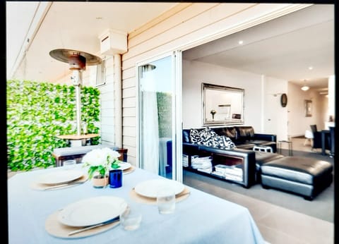 Front balcony with 4 burner gas bbq, Weber kettle bbq, gas heater, table/chairs