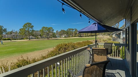 Enjoy wide, open views across the manicured golf course from this inviting covered balcony setting.