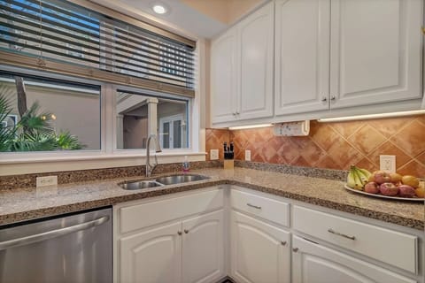 Freshly painted kitchen cabinets and blinds complete this updated kitchen.