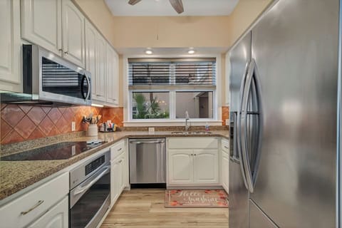 Fully outfitted kitchen with everything needed to cook a family meal. Added touch is a ceiling fan in the kitchen. The fridge has water and ice in the door. 
