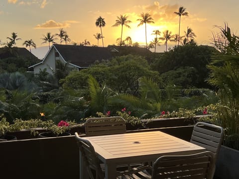 Outdoor dining on lanai with sunset and ocean view 