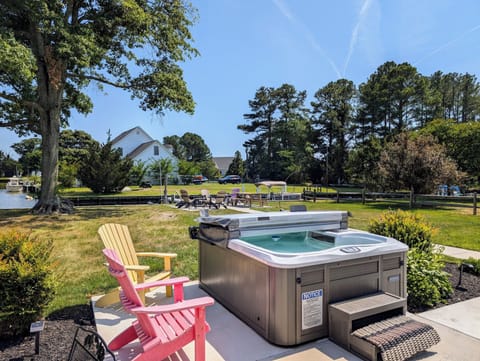 38166 Bow Street, Ocean View - hot Tub - Private outdoor oasis featuring a modern, multi-jet hot tub surrounded by professional landscaping and lawn space.