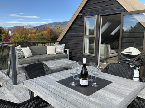 Outdoor deck which is off lounge upstairs. Outdoor seating, dining and BBQ area.