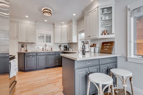 Your gourmet kitchen awaits with elegant cabinetry, granite countertops, and a welcoming breakfast bar perfect for morning coffee or casual meals.