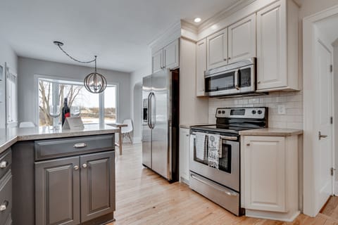 Your fully equipped kitchen awaits with stainless steel appliances, granite countertops, and elegant pendant lighting for memorable meal prep.