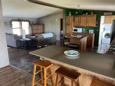 breakfast bar, kitchen and entry side living room area
