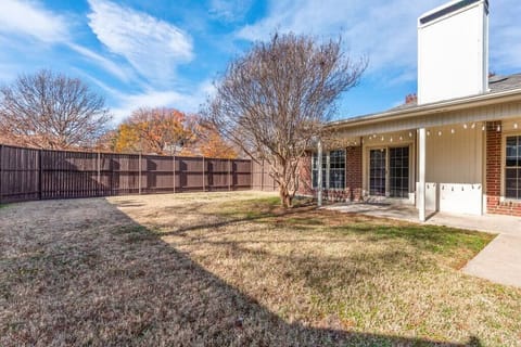 Large fenced in private backyard with covered patio.