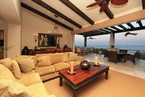 Living area with high beamed ceilings and beautiful furniture opening to terrace