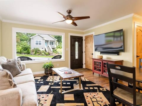 Clean, cozy, inviting living room with curved TV