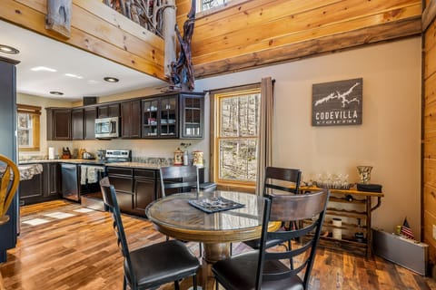 Breakfast table, wine rack adjacent to kitchen on main level