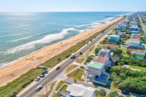 Aerial view of the beautiful 3-bedroom vacation rental on N Ocean Shore Blvd in Flagler Beach, showcasing stunning ocean views and a private pool.