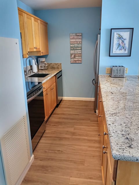 Granite countertops and stainless steel appliances in kitchen