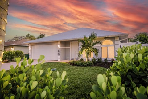 Front of the Coastal Beach House located in Naples Park, early evening.