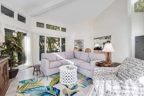 Living Room Retreat: Bright and airy space with tropical decor and abundant natural light!
