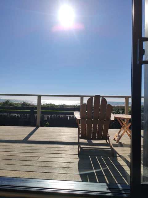 View from lounge out to deck and across to the ocean. 