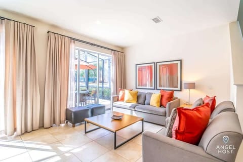 Kick back in the cozy living room and enjoy the lively patio view.