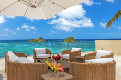 Guest bedrooms shared lanai, offering serene mountain views and a peaceful retreat.