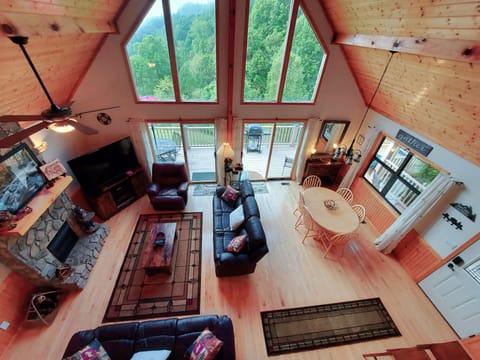 Roomy & open living space under the tall cathedral ceilings and wall of windows