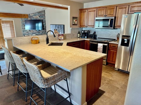fully stocked kitchen with NEW leathered quartzite counters. 