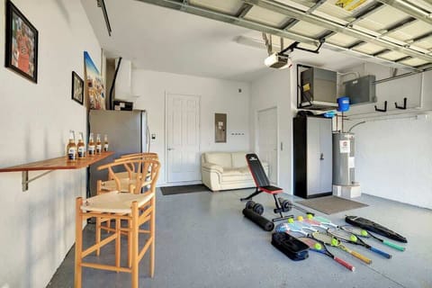 This multi-use garage space is designed for fun and relaxation — featuring a bar area, comfortable lounge seating, tennis and pickleball equipment, plus workout gear to keep you active during your stay.