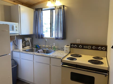 Full Kitchen with Refrigerator, Stove/Oven, Microwave, Coffee Pot, and Toaster