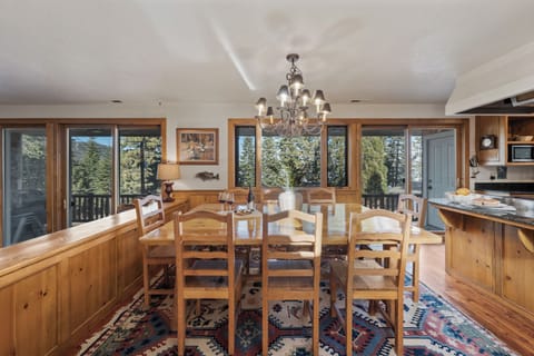 Spacious dining area with forest views, perfect for gathering and shared meals.