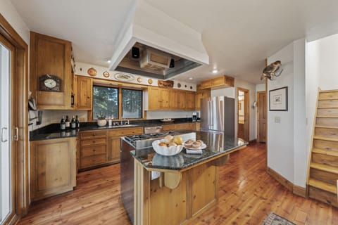 Spacious, fully equipped kitchen with a large island and warm wood finishes.