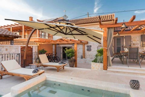 Deck chairs by the pool of a Croatian luxury vacation villa with concierge service and private parking in Skradin