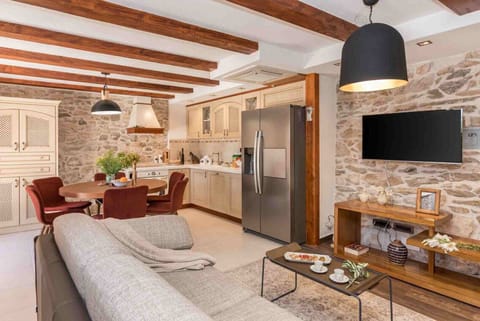 Comfortable sofas and TV in a living room of a luxury pet-friendly villa for vacation with friends in Skradin