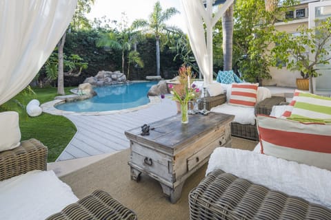 Outdoor Lanai with overhead fan and ample seating.