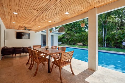 Terrace next to the heated pool, with a Smart TV.