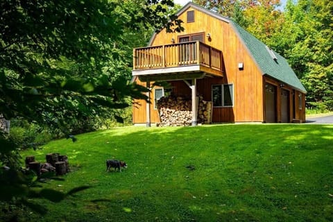 The guest house with the fire pit & Charlie in the foreground 9-16-2021