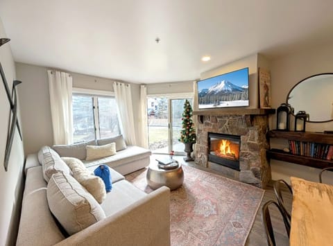 Cozy living area with large tv, views and a cozy fireplace