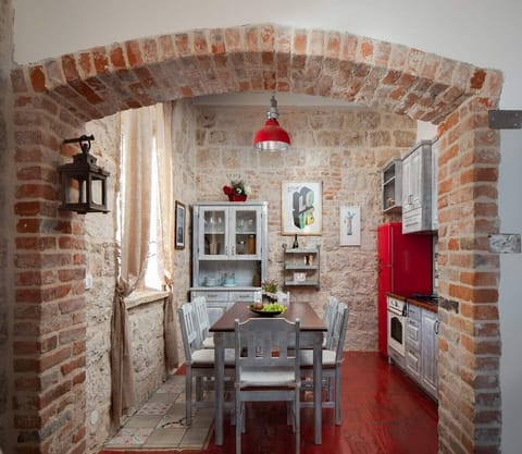 Equipped kitchen and rustic dining room in Vis luxury private villa for vacation and rent.