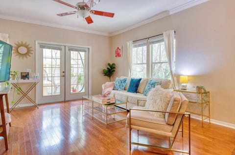 Sun-soaked living room with large windows and soft pottery barn couch.