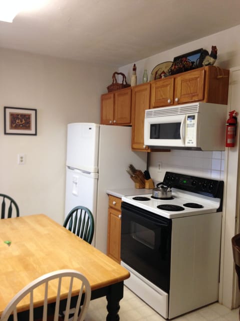 Kitchen electric stove refrigerator and microwave.