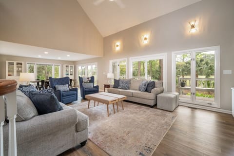 Open concept living area with ample seating. Large windows provide natural light.