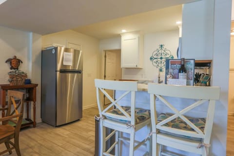 There are two high top stools at the kitchen counter.