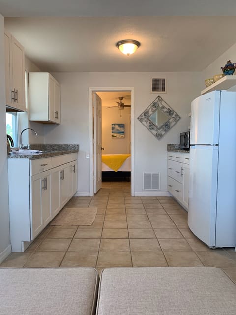 This is both sides of the kitchen with a view into the bedroom.