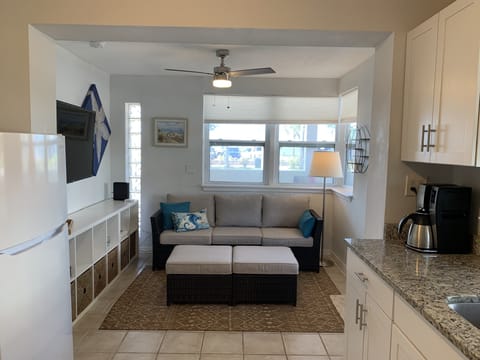 Deeper view of living room from kitchen. Bookcase & TV to the left in the photo.