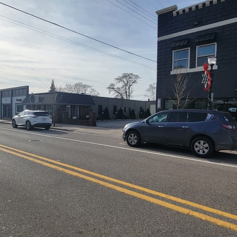 You will see an alley right after the building