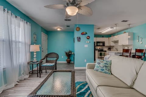 Living Area - The entire unit is adorned with coastal colors and  beach vibes. No way you will wake up and wonder where you are!