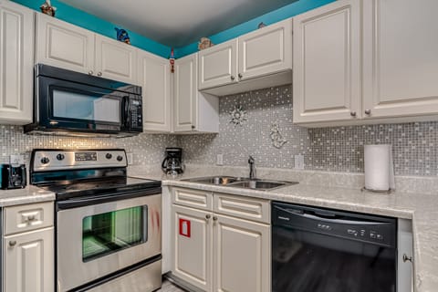 Kitchen - A dishwasher, electric range stove and built in microwave are included in the appliance package this great unit offers. The cabinets are fully stocked with all items needed for meal prepping.