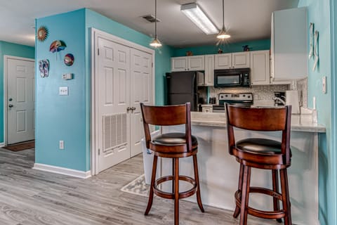 Kitchen - The spacious kitchen offers everything you need for meal prepping while at the beach. The small bar offers 2 additional seats for meal time.