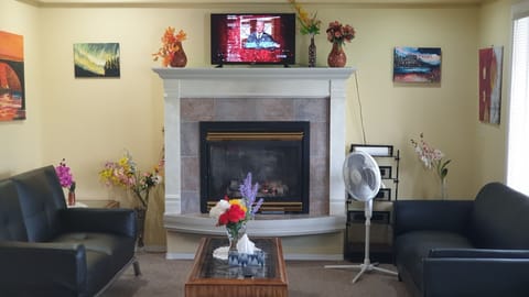 Living room with fireplace and comfy sitting .