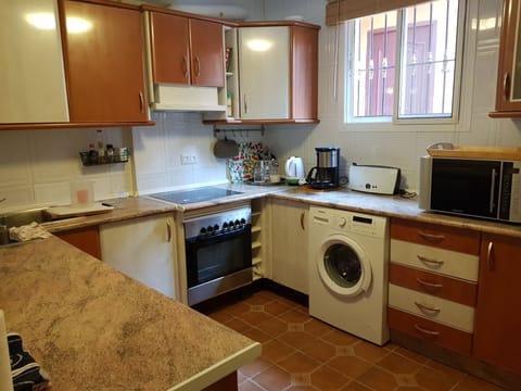 Kitchen with fridge, freezer, washing machine, dishwasher, oven, microwave etc.