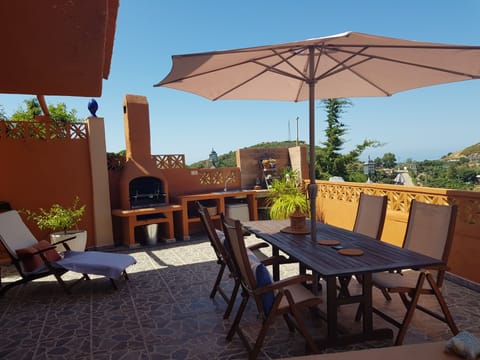 Large private terrace with barbecue and outdoor kitchen; views to sea and pool