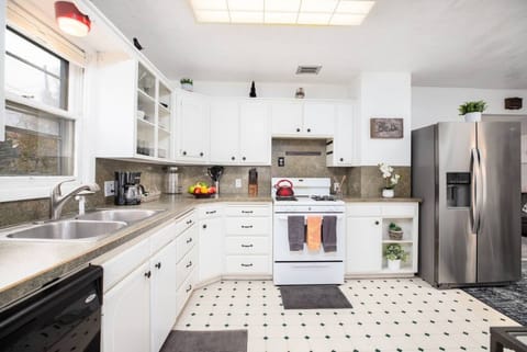 Experience culinary convenience in our spotless kitchen, complete with all essentials and a modern refrigerator.