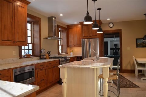 Kitchen includes island and table for four.